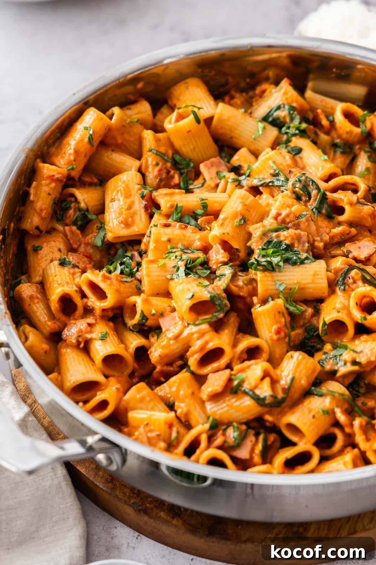 Creamy Bacon & Tomato Pasta Recipe for Busy Weeknights 2 Large pan of Creamy Bacon and Tomato Pasta, garnished with some finely chopped fresh basil.