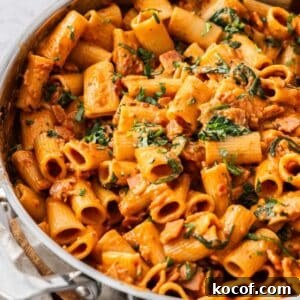 Creamy Bacon & Tomato Pasta Recipe for Busy Weeknights 14 Large pan of Creamy Bacon and Tomato Pasta, garnished with some finely chopped fresh basil.