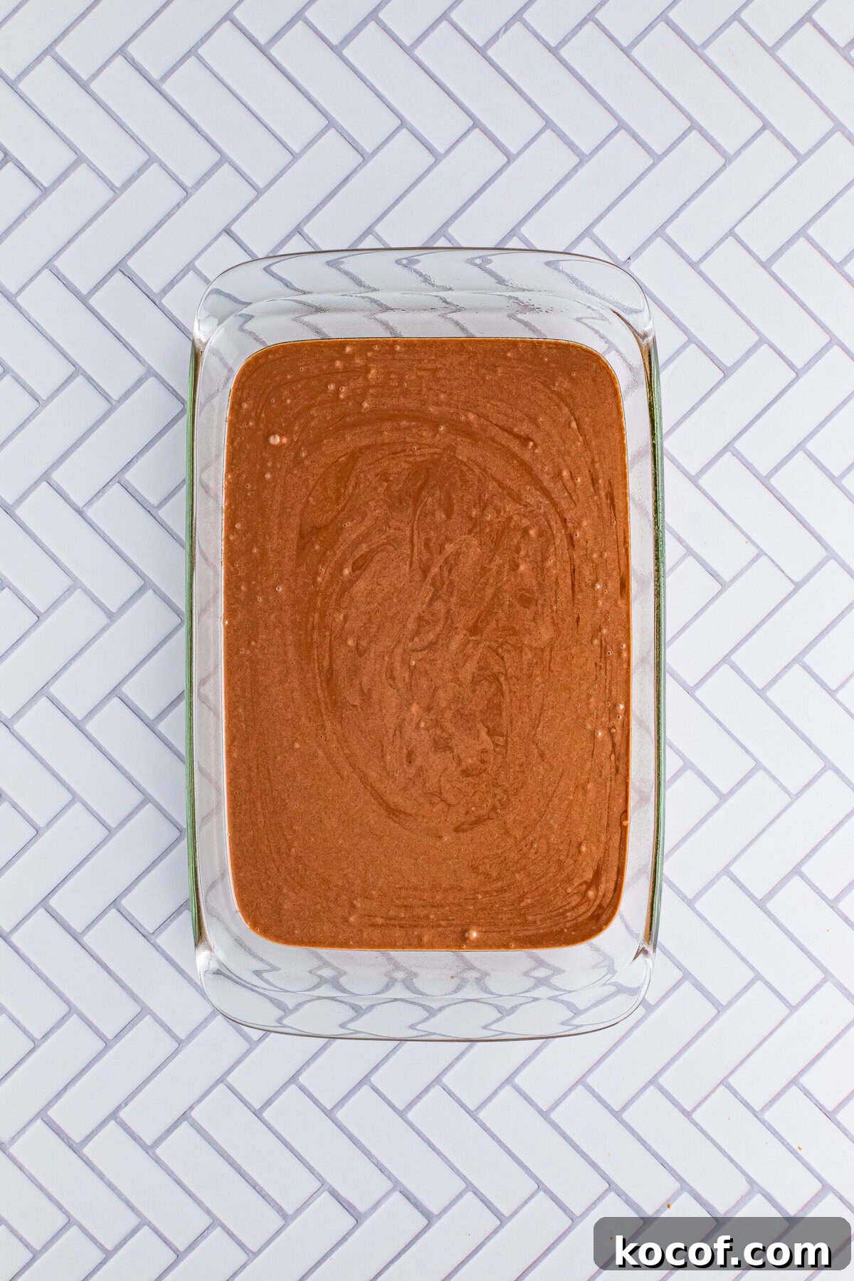 Chocolate cake batter mixed and poured into a 9x13 baking dish prepared for the Italian Love Cake Recipe.