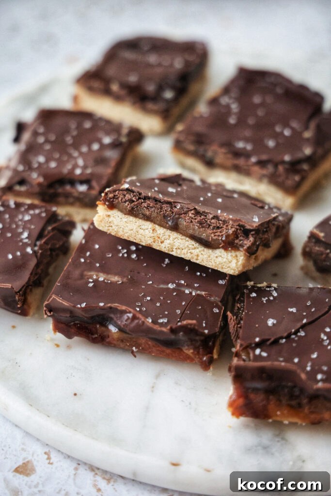 Vegan millionaire's shortbread bars on a marble plate.