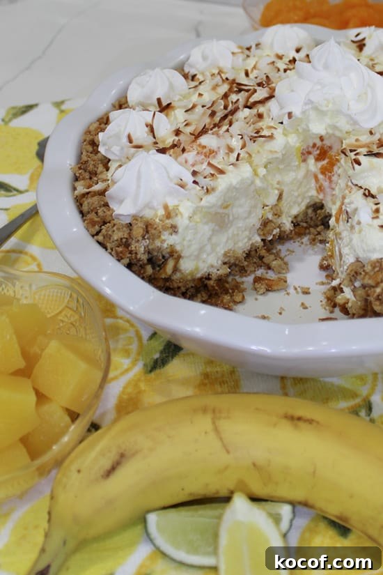 Piece of pie missing from a coconut topped dessert.