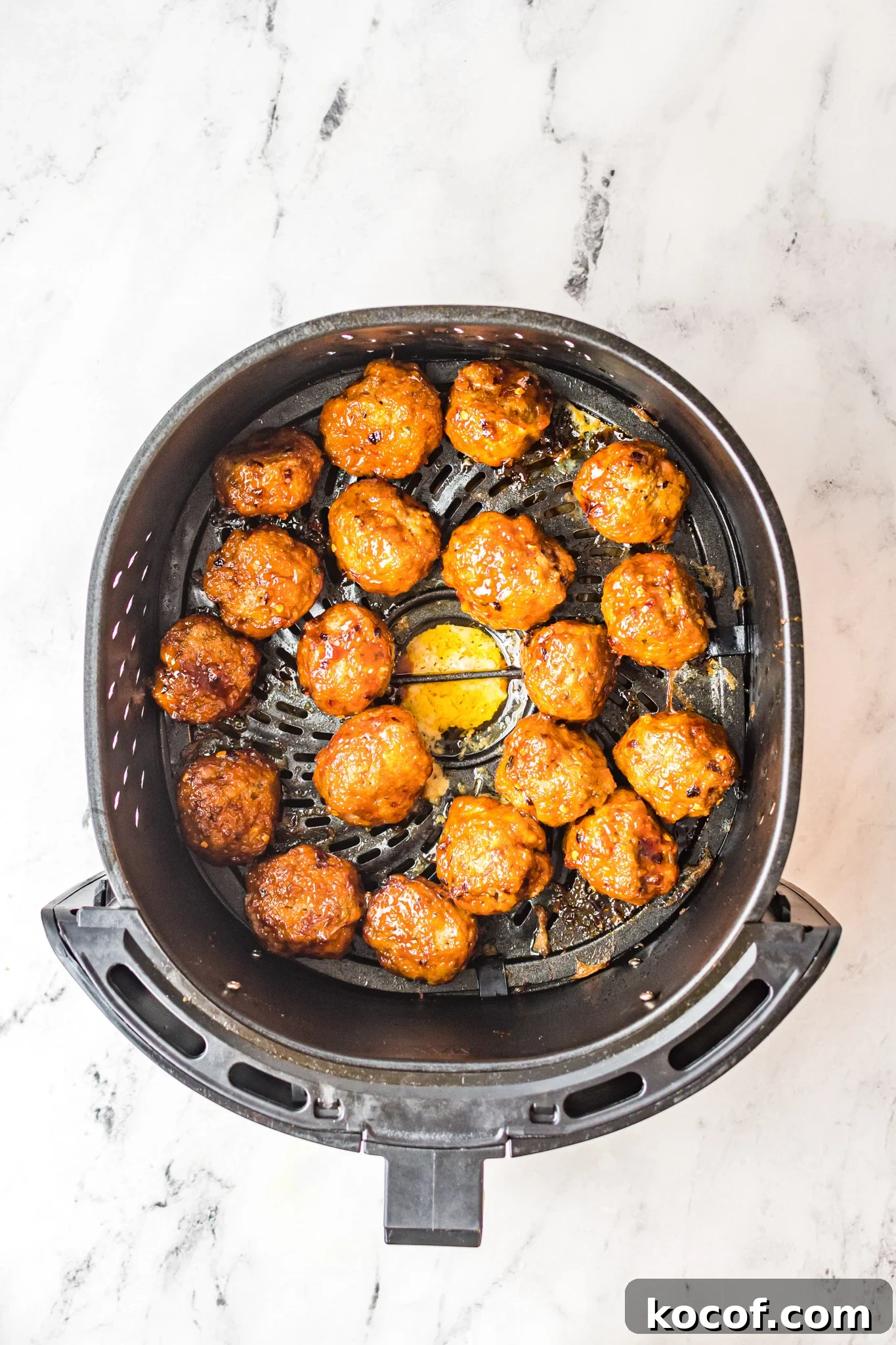 Crispy Air Fryer Meatballs Recipe for Quick Weeknight Meals 8 Air Fryer Meatballs in an air fryer.