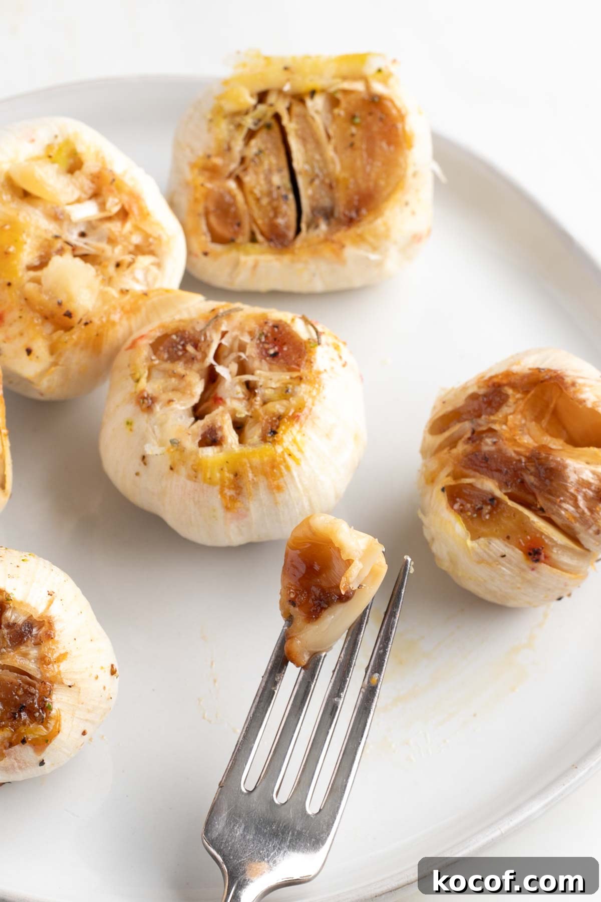 Oven-Roasted Garlic Bulbs: Crispy, Sweet Garlic Recipe 11 Clove of roasted garlic pulled from an entire head that's golden brown.