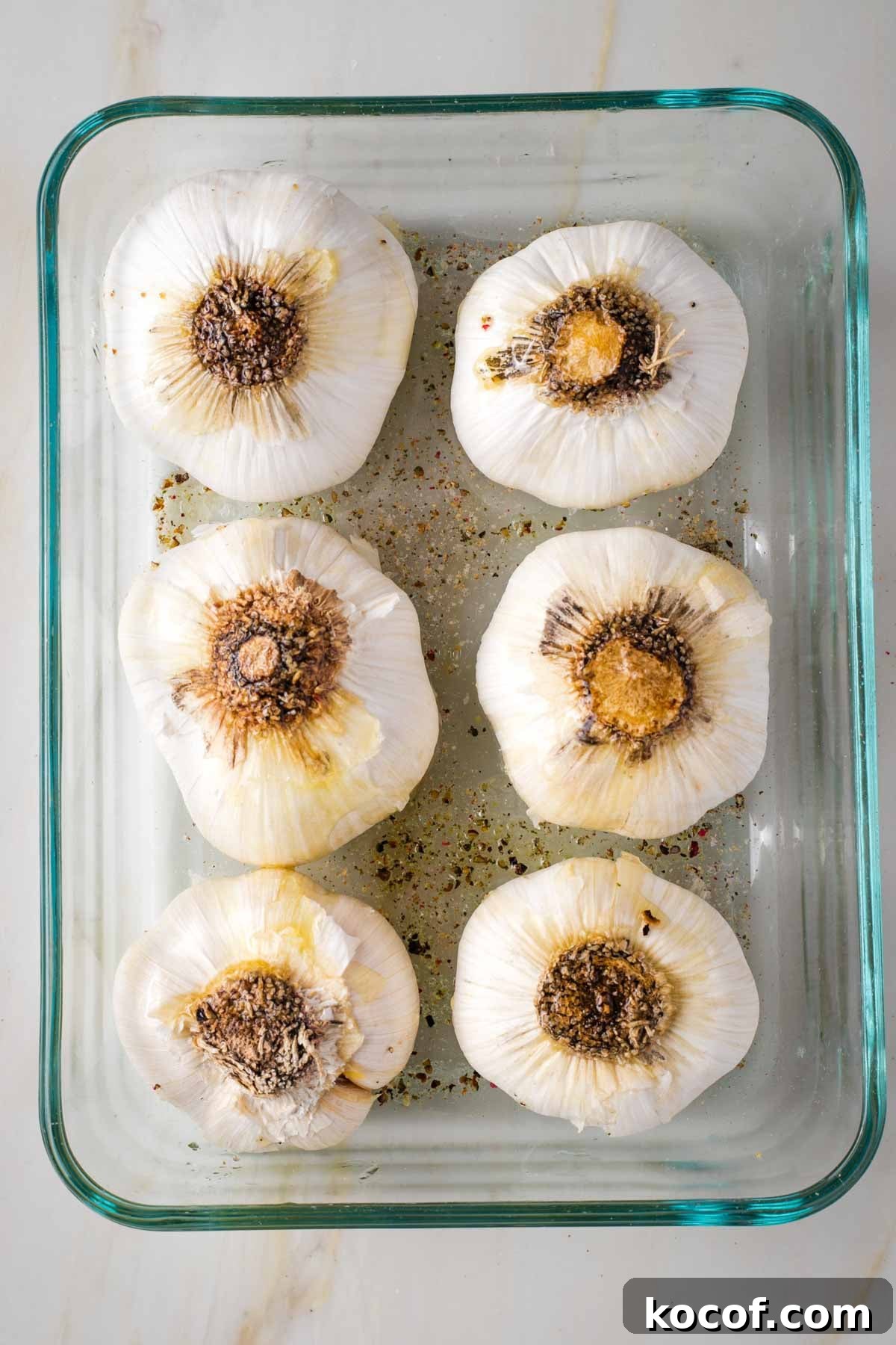 Oven-Roasted Garlic Bulbs: Crispy, Sweet Garlic Recipe 6 6 heads of garlic, root side up in a small baking dish.