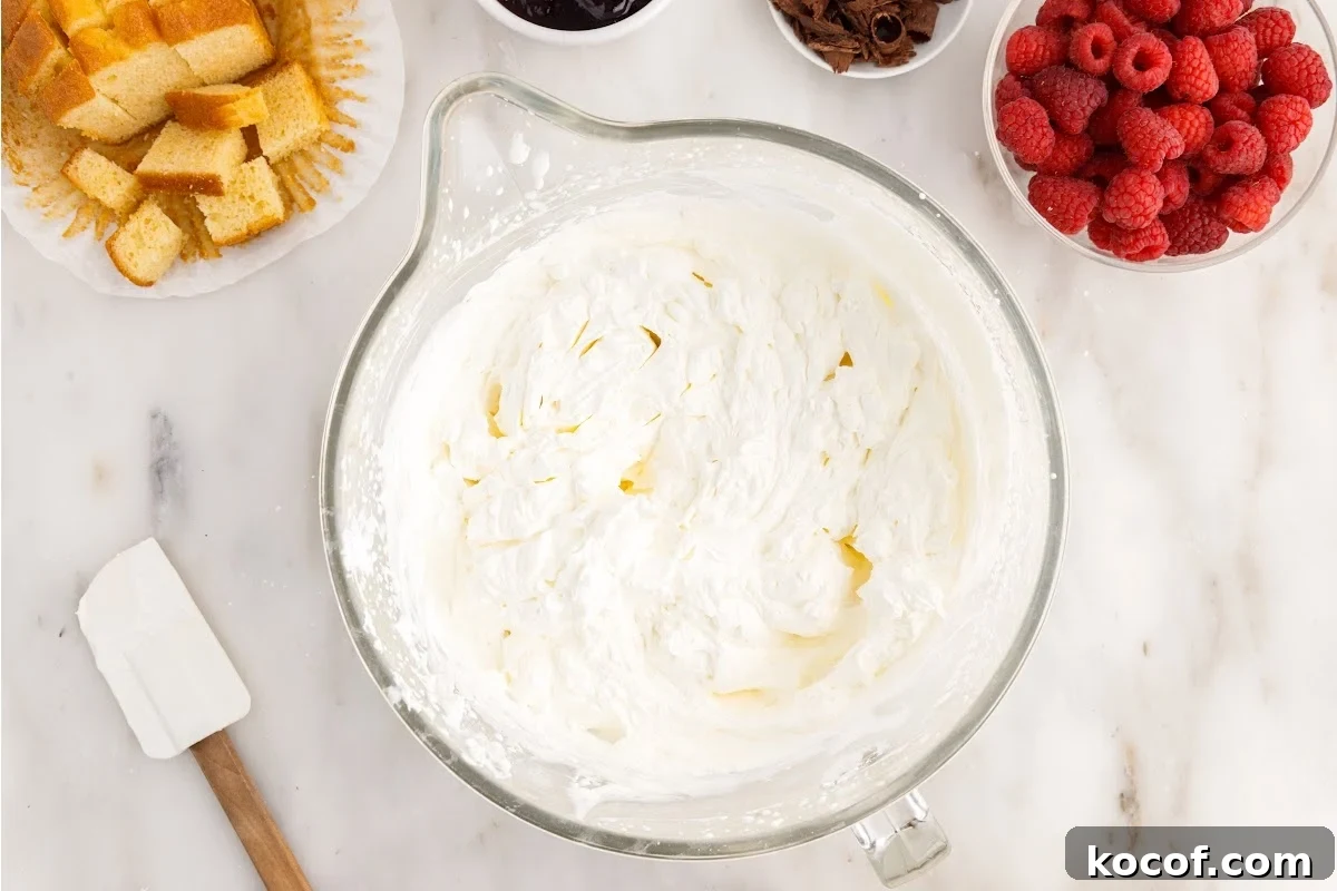 Decadent Raspberry Trifle Recipe with Layers of Cream and Cake 5 Cream cheese mixture in a mixing bowl.