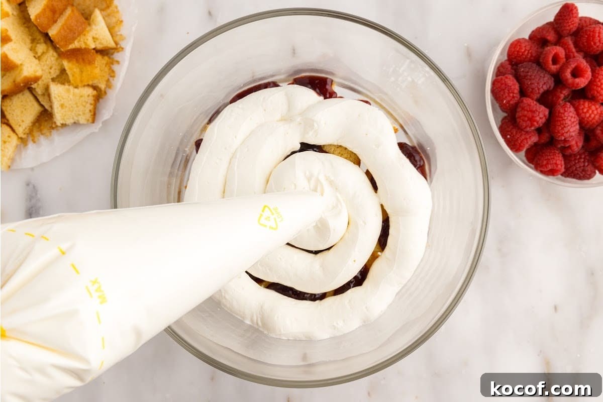 Decadent Raspberry Trifle Recipe with Layers of Cream and Cake 8 Cream cheese mixture piped on top of the raspberry mixture.