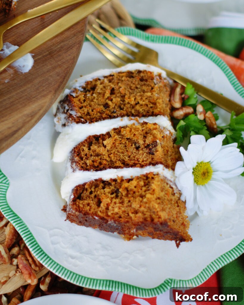 A slice of 3 layer carrot cake to show off the layers, texture of the cake and frosting.