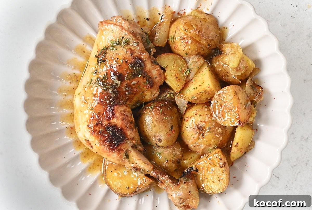 Honey Mustard One-Pan Chicken and Roasted Potatoes 10 chicken and potatoes in a scalloped bowl