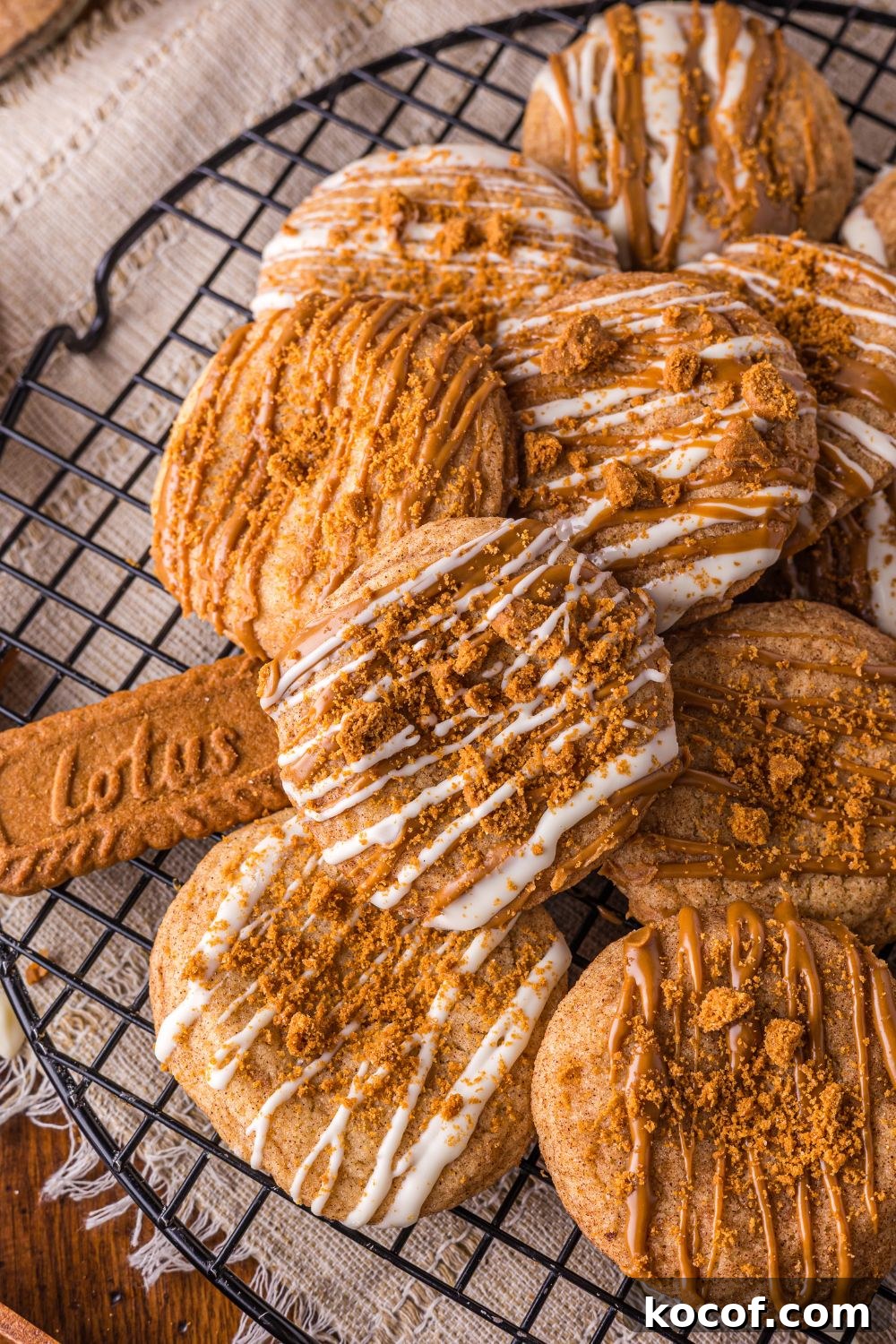 Biscoff Snickerdoodle Cookies on a cooling rack with Lotus cookies around the table 