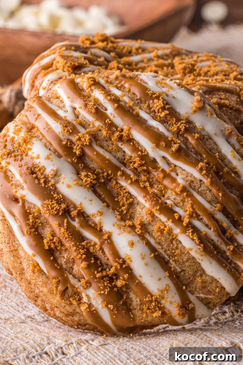 Biscoff Snickerdoodle Cookie tilted on the side that is topped with cookie crumbles and white chocolate