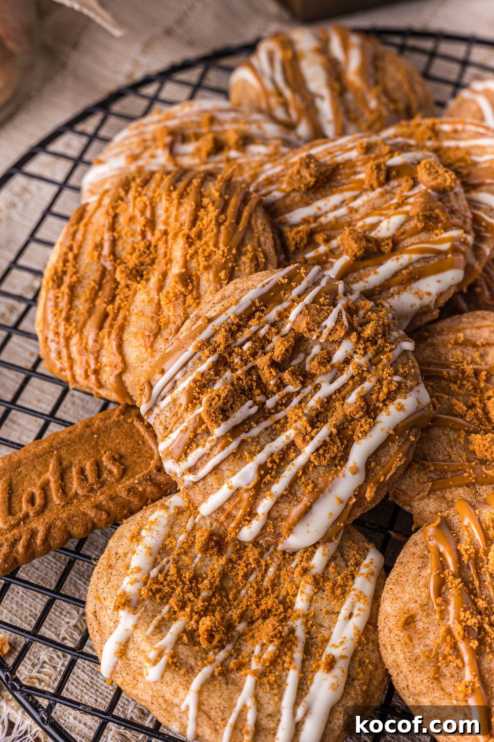 Biscoff Snickerdoodle Cookies stacked on top of one another on a wire cooling rack