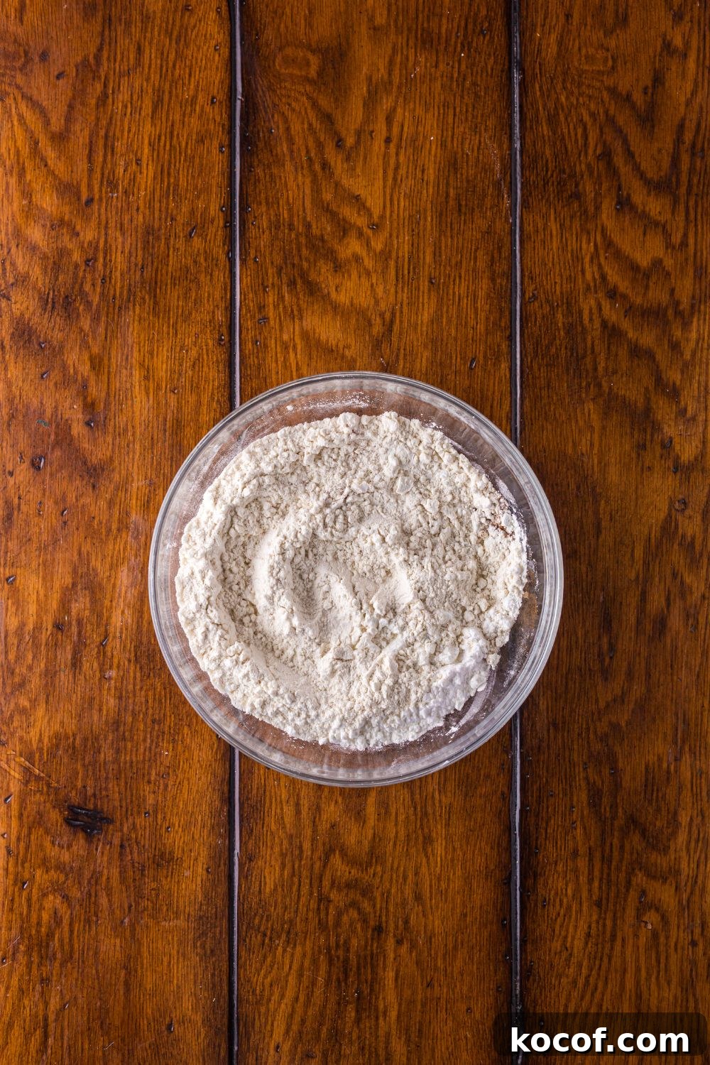 dry ingredients in a glass bowl on a wooden table