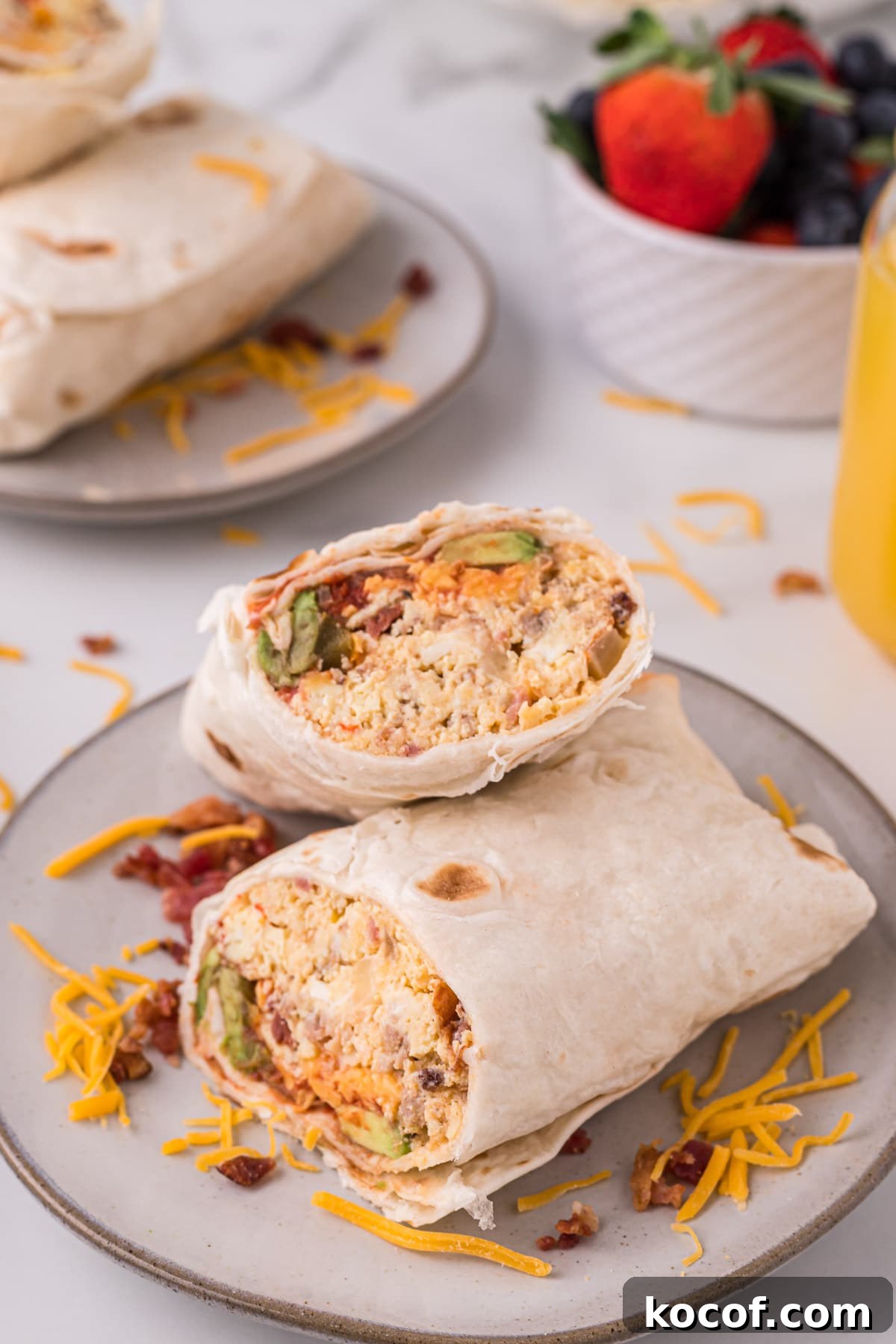 Make-Ahead Slow Cooker Breakfast Burritos for Busy Mornings 2 close up of a breakfast burrito on a plate