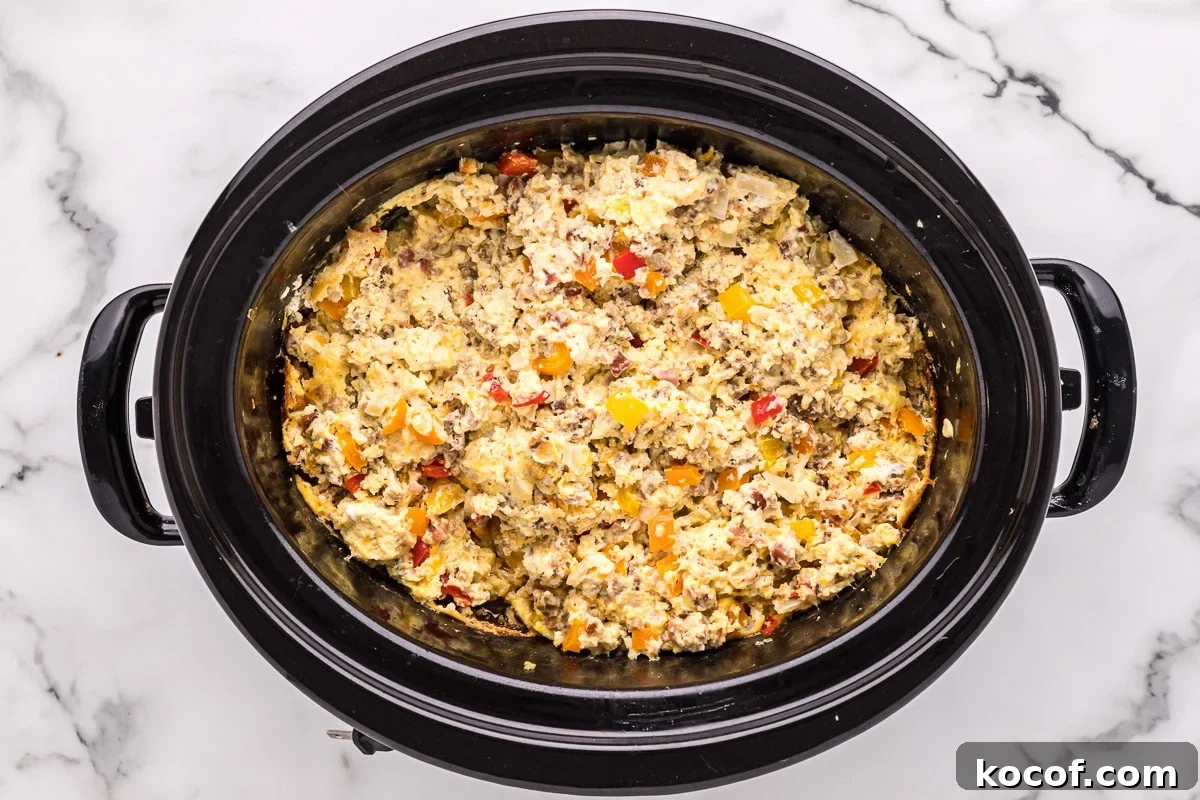 Make-Ahead Slow Cooker Breakfast Burritos for Busy Mornings 5 close up of breakfast burrito filling in slow cooker