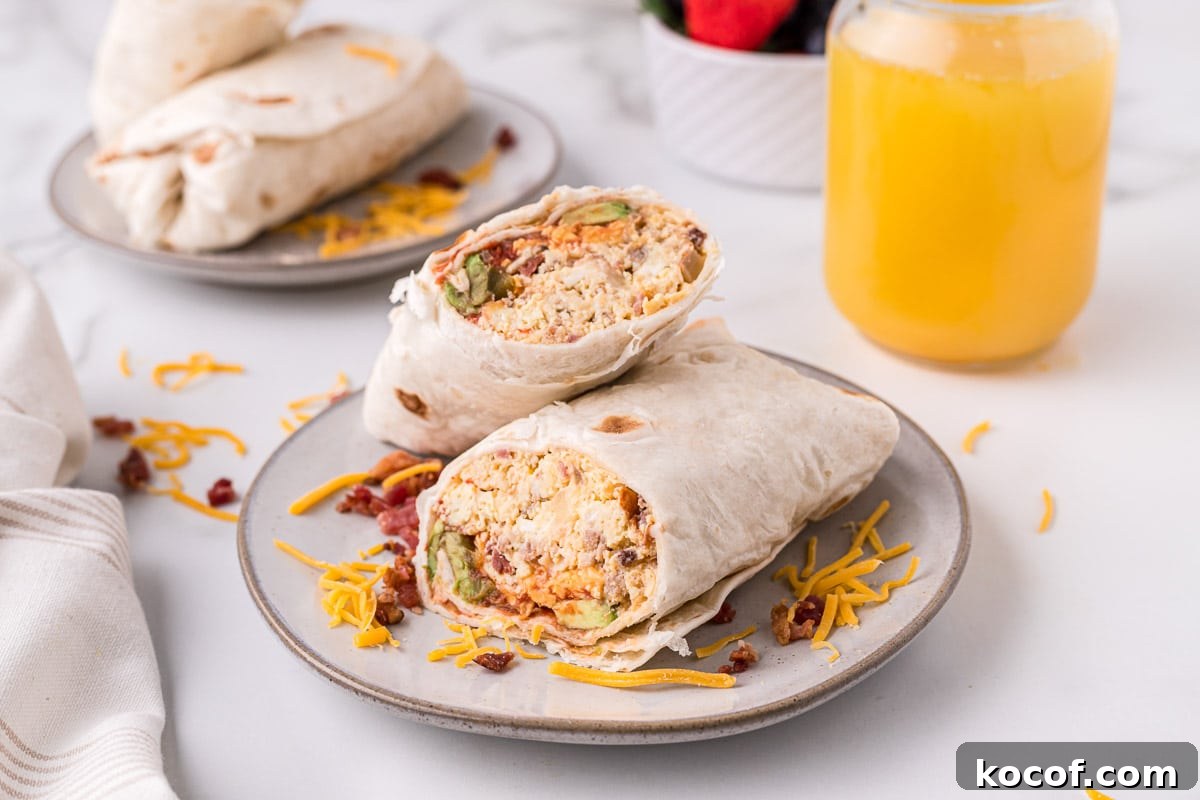 Make-Ahead Slow Cooker Breakfast Burritos for Busy Mornings 7 breakfast burritos sliced in half on plate