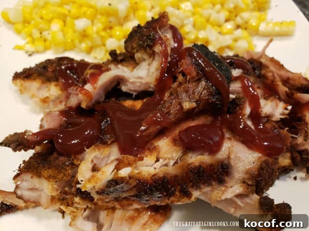 Baked Grilled Baby Back Ribs - The Grateful Girl Cooks! BBQ sauce on the baby back ribs, with fresh corn kernels on the side.