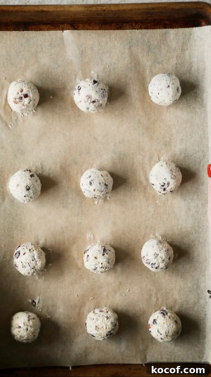 Cranberry Orange Cheesecake Bites: Festive Party Appetizer 7 Cheese balls on a pan.
