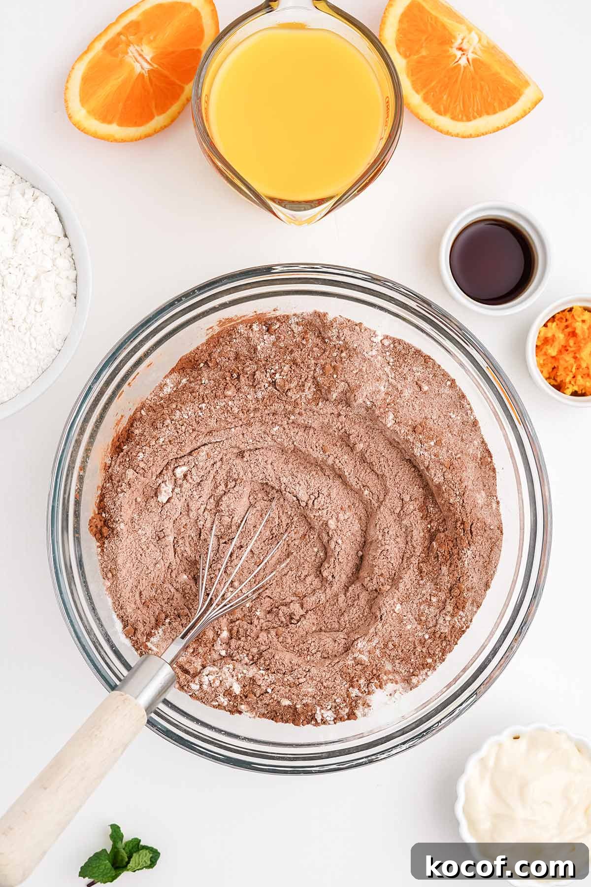 Mixing the dry ingredients together to make a chocolate orange cake recipe.