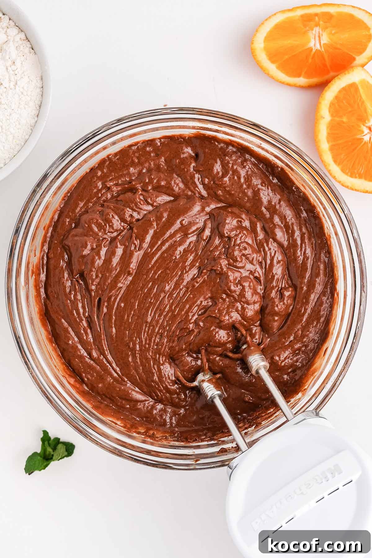 Using a hand mixer to make the batter for a chocolate orange cake recipe.