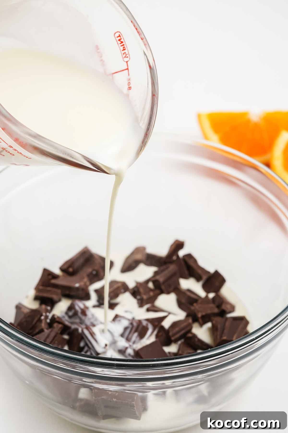 Adding the milk to the chocolate to make ganache.