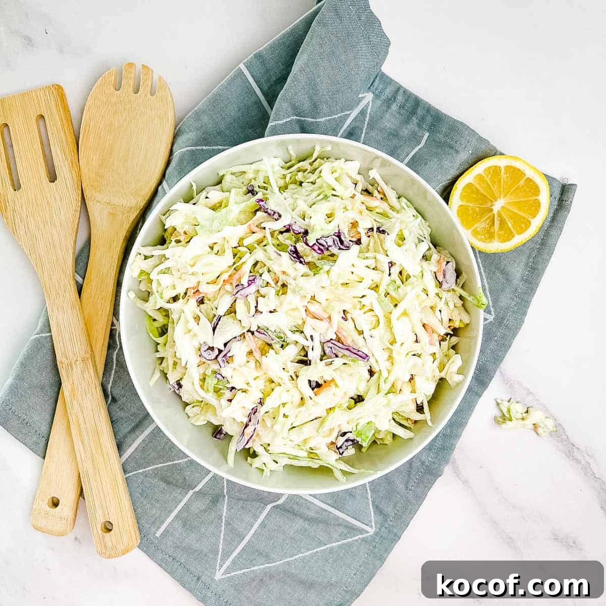 A closeup of homemade coleslaw in a white bowl.