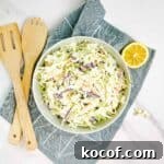 A closeup of homemade coleslaw in a white bowl.