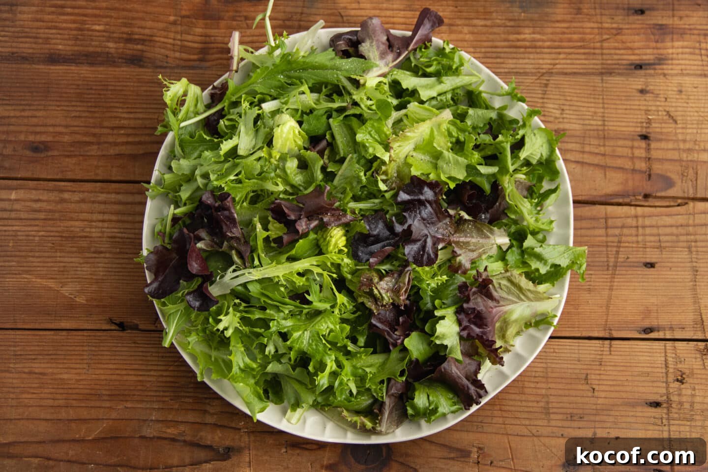 This is a picture of mixed greens with salt and pepper.