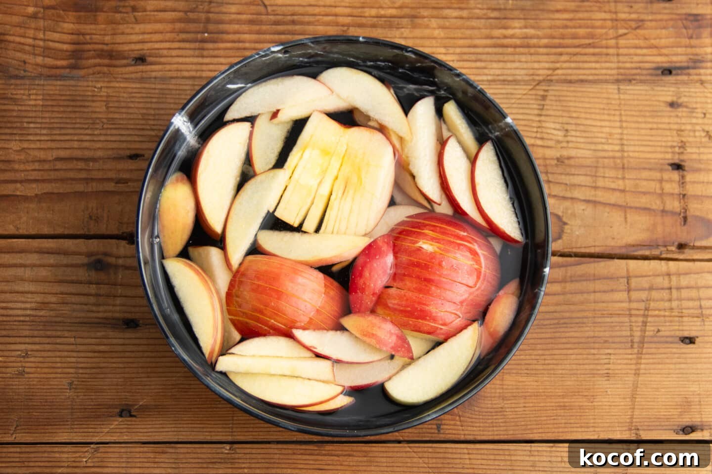 This is a picture of apples in a bowl of salt water.