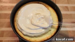 sour cream mixture on cheesecake