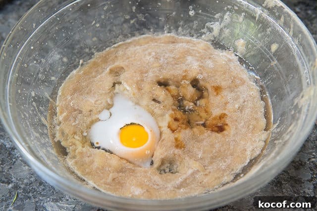 Pureed Bananas in Bowl with Egg, Oil, and Vanilla Extract
