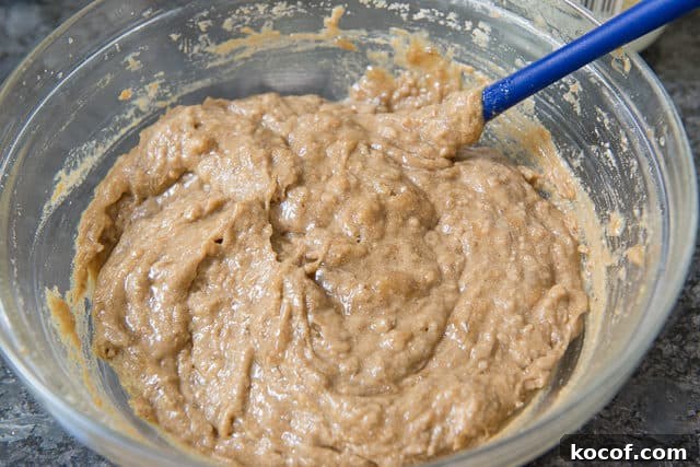 Banana Bread Batter in a Glass Bowl with Thick Texture