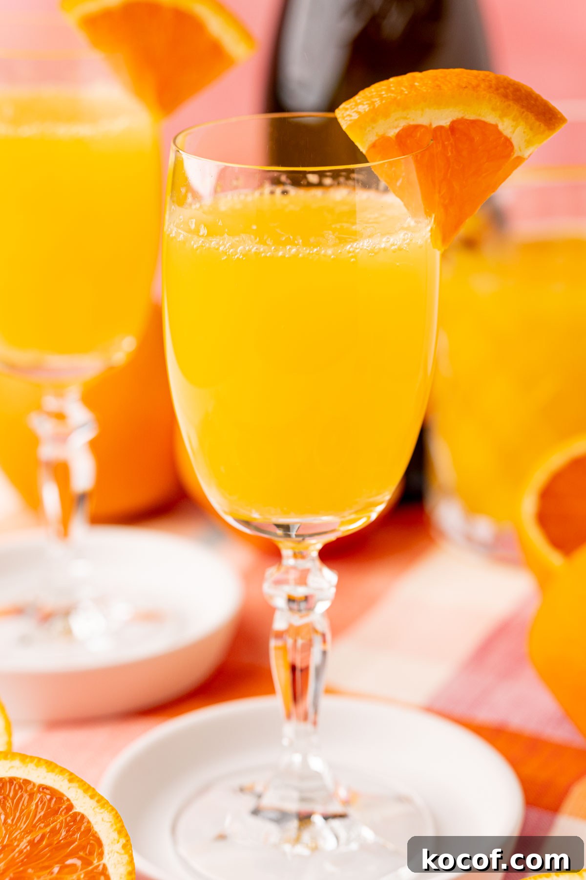Close up of a mimosa garnished with orange.