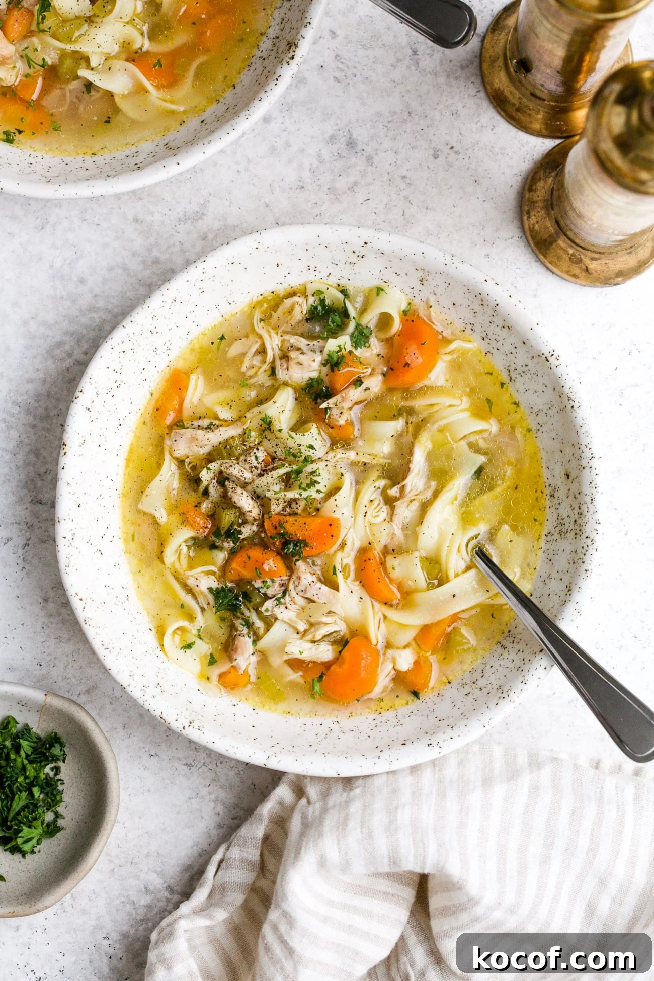 Creamy Instant Pot Chicken Noodle Soup Recipe 2 Instant pot chicken noodle soup in a white serving bowl.