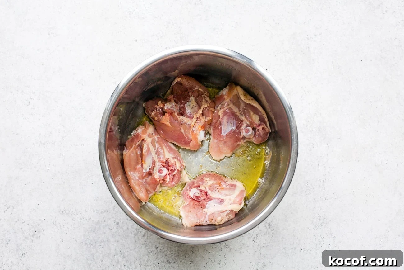 Creamy Instant Pot Chicken Noodle Soup Recipe 4 Sautéing chicken thighs in the Instant Pot.