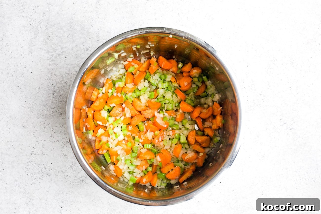 Creamy Instant Pot Chicken Noodle Soup Recipe 5 Sautéing onion, carrots and celery in the Instant Pot.