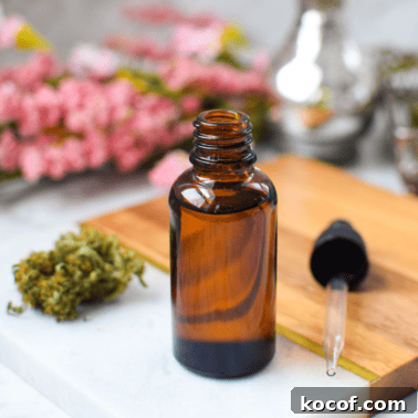 How to Decarboxylate CBD Flower Safely (Lab-Tested Method) 18 A picture of a bottle of CBD oil with fresh cananabis buds.