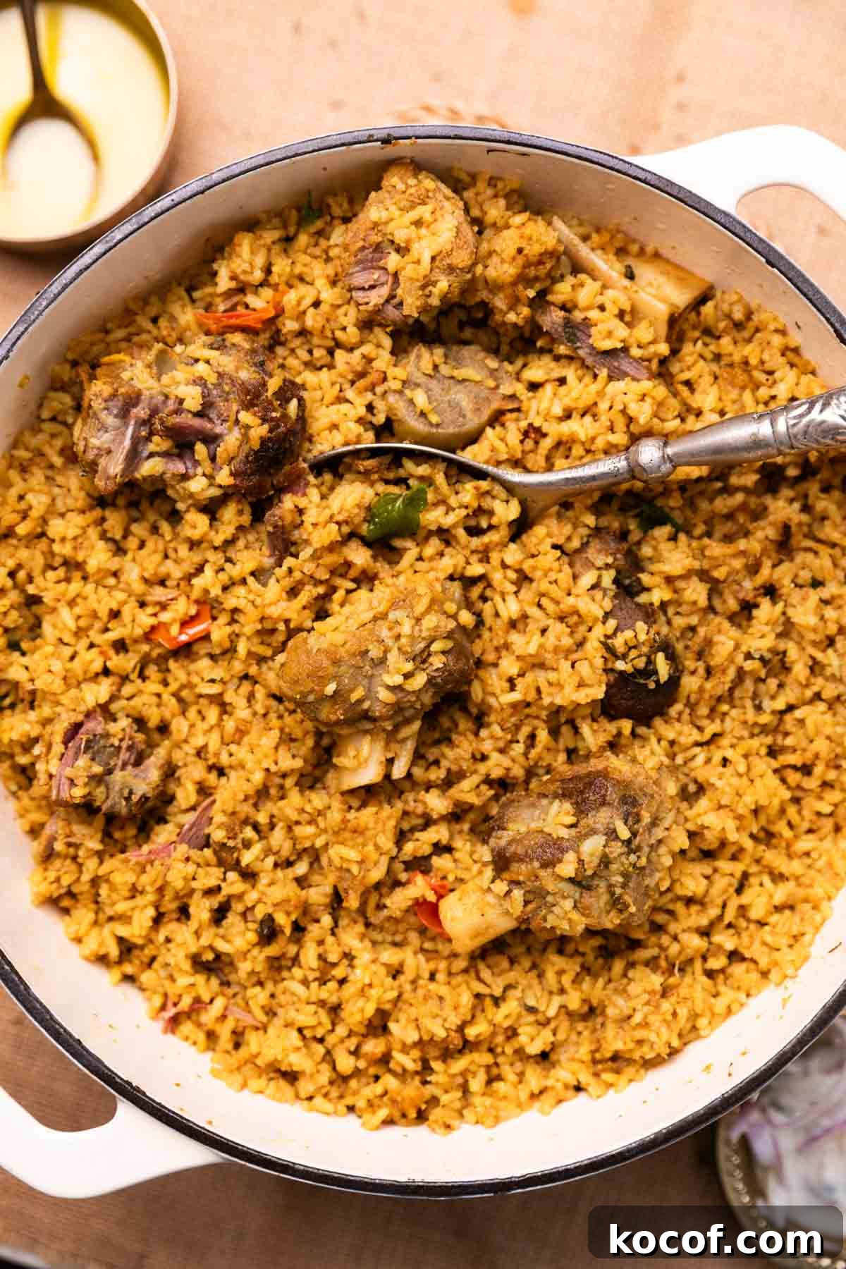 dindigul mutton biryani in a pan with spoon