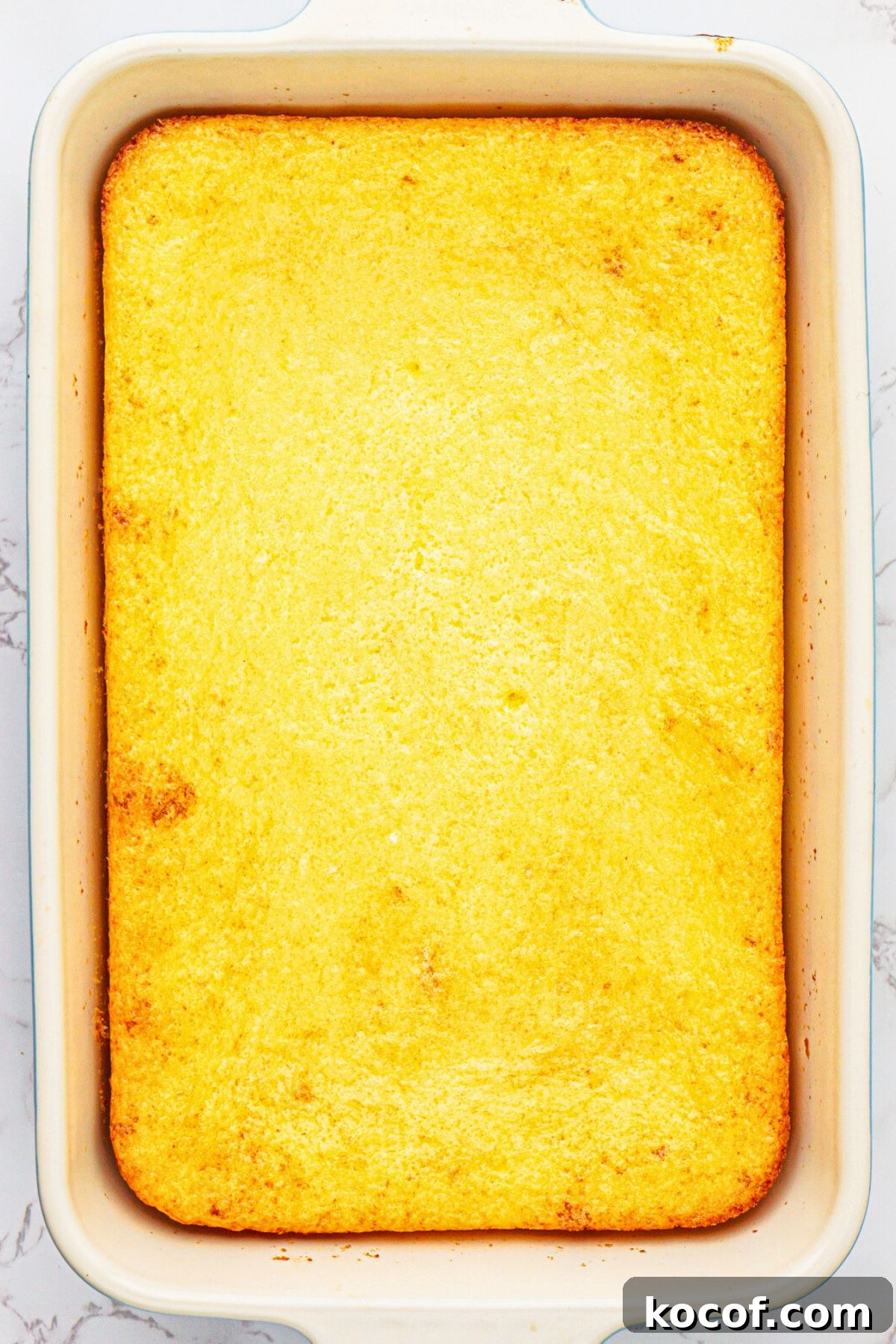 Lemon cake mix and pie filling in pie dish after they have been mixed and baked in a 9x13 baking dish. 