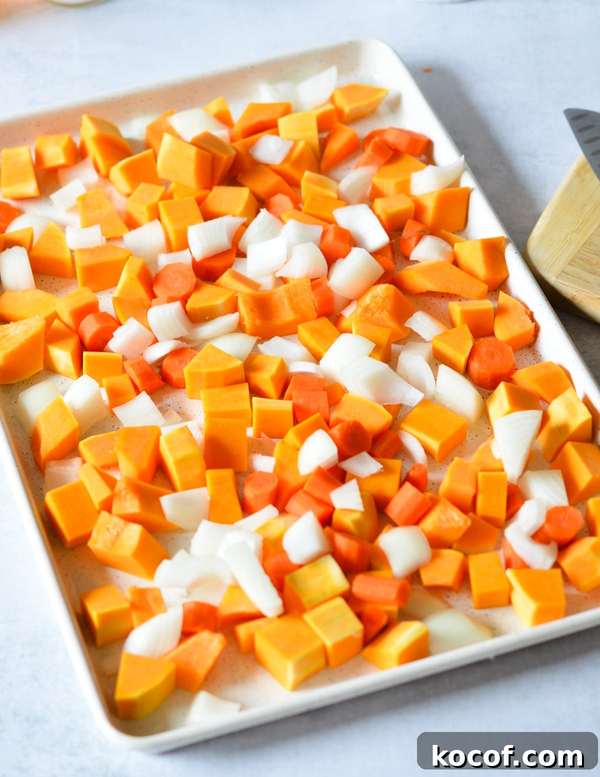 butternut squash, onion, and carrots on a sheet pan.