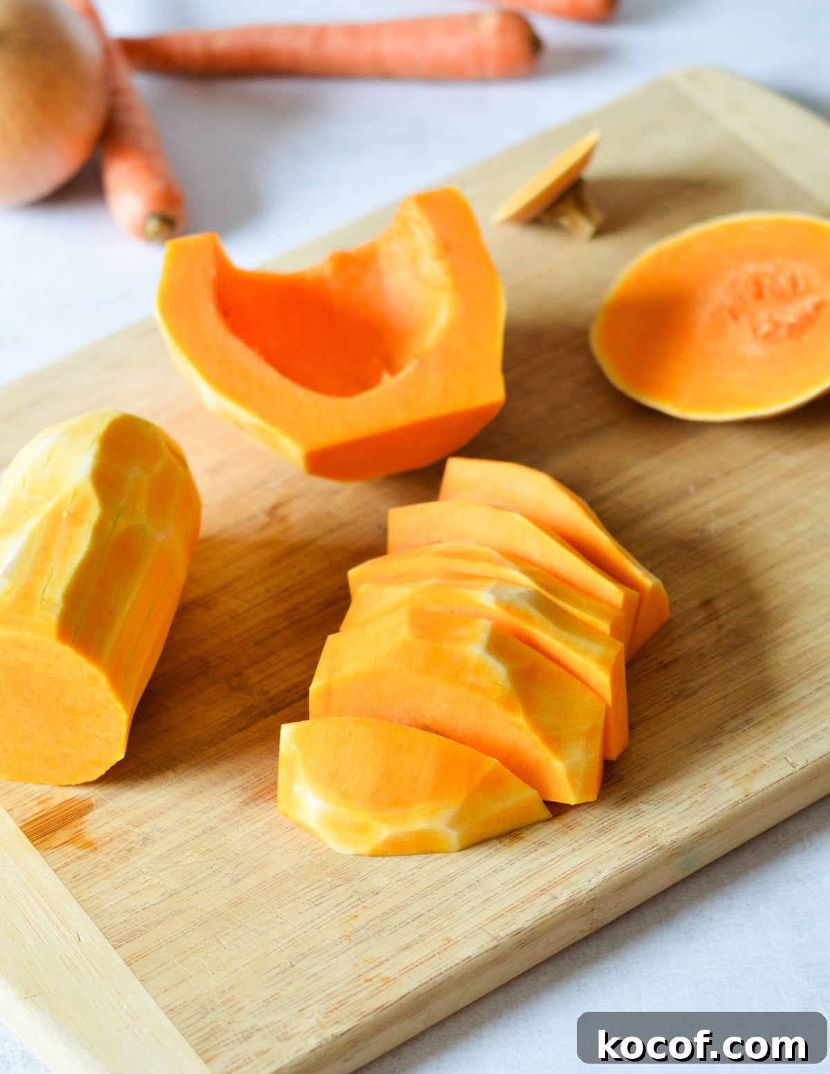 butternut squash cut into strips on a cutting board. 