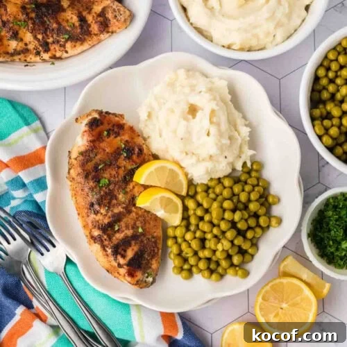 9 Juicy Grilled Chicken Recipes That Stay Moist Every Time 6 Grilled lemon pepper chicken with mashed potatoes and green peas on a white plate.