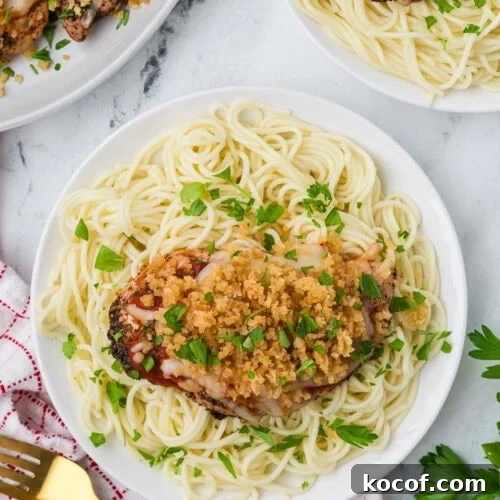 9 Juicy Grilled Chicken Recipes That Stay Moist Every Time 7 Juicy chicken thigh with breadcrumb topping served over spaghetti pasta in a white bowl.