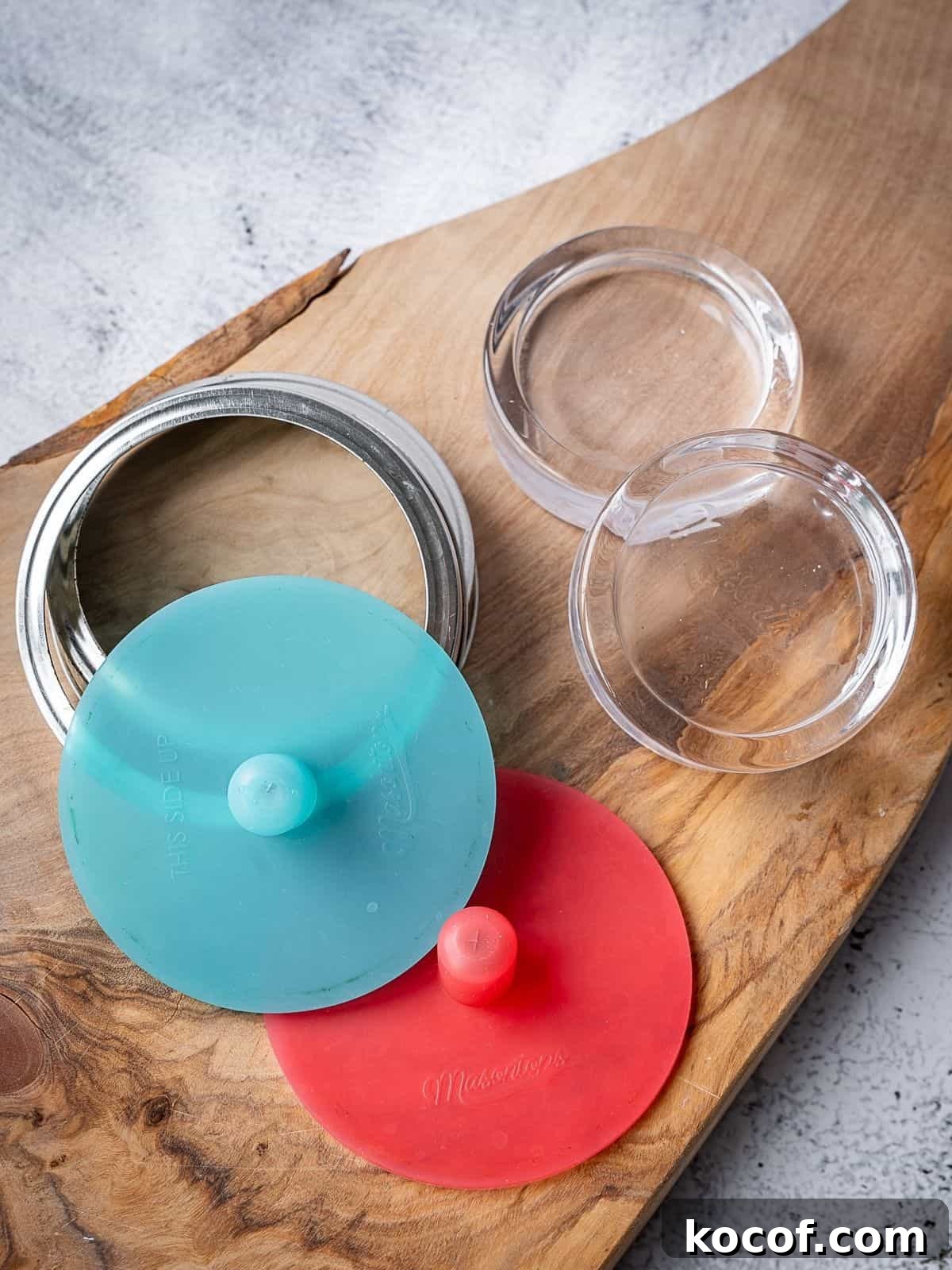 Fermenting weights and lids on a wooden board.