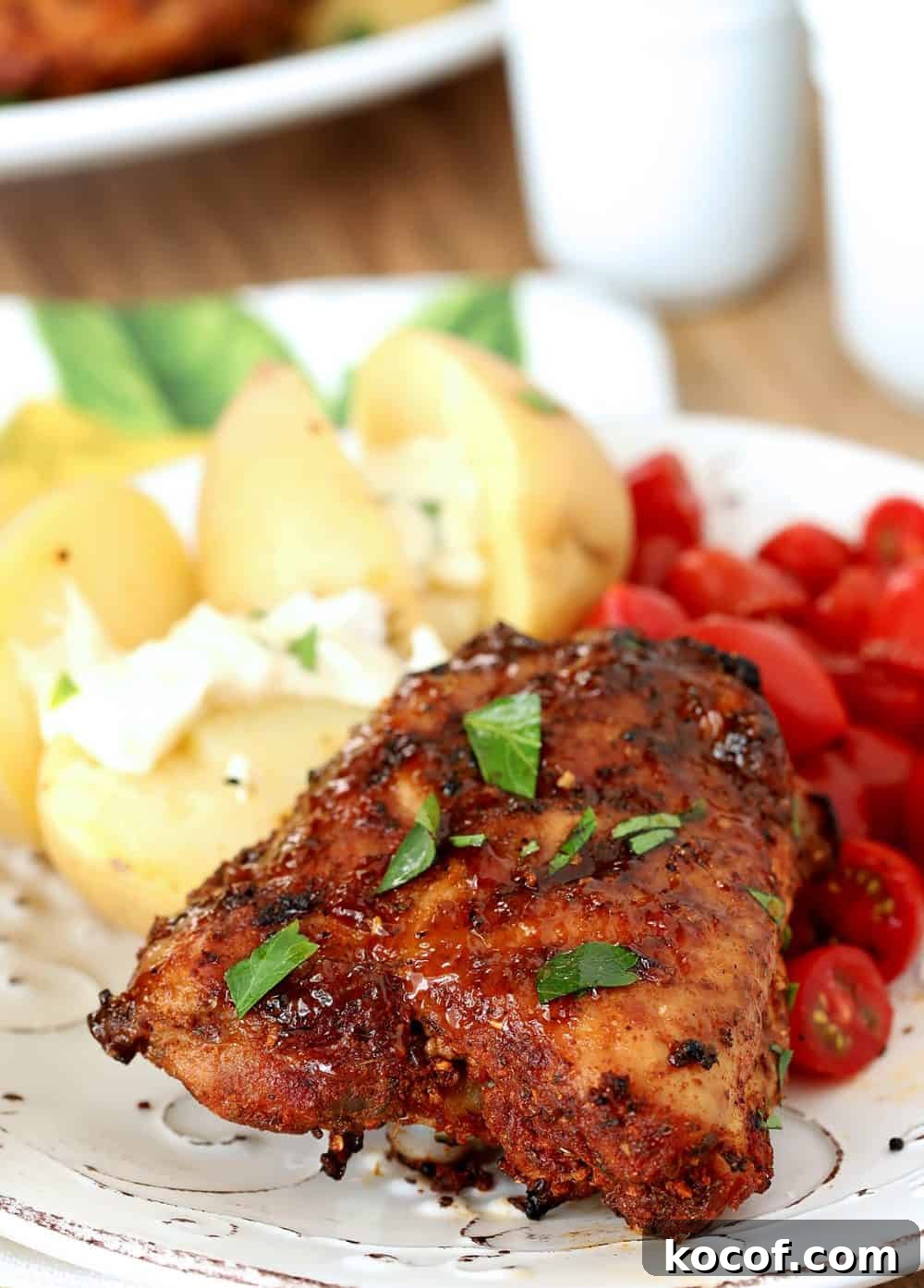 Spanish-Style Tapas Chicken Recipe for Flavorful Small Plates 4 Individual serving of Spanish Tapas Chicken Thighs served with potatoes and tomatoes.