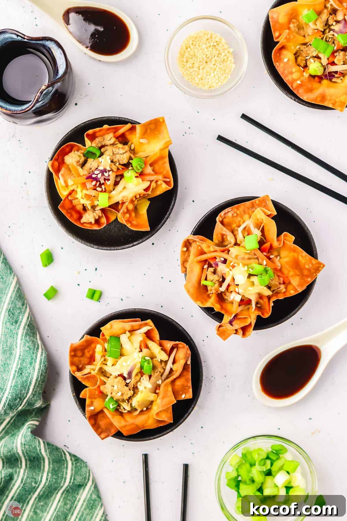 overhead picture of 3 egg roll cups on black plates