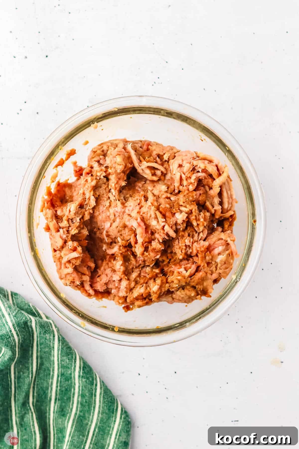 ground chicken and marinade in a clear bowl