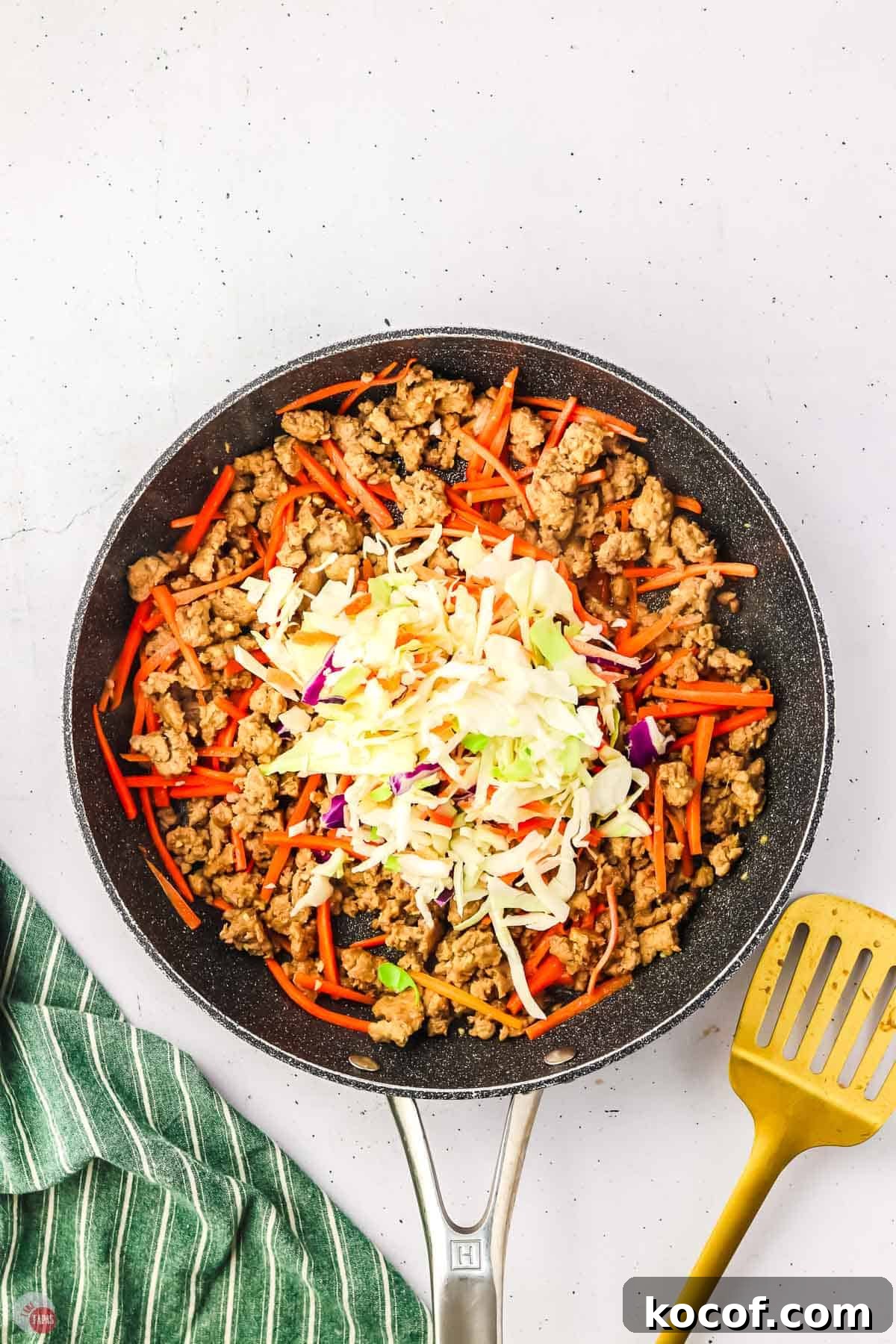 skillet with cooked ground chicken and vegtables