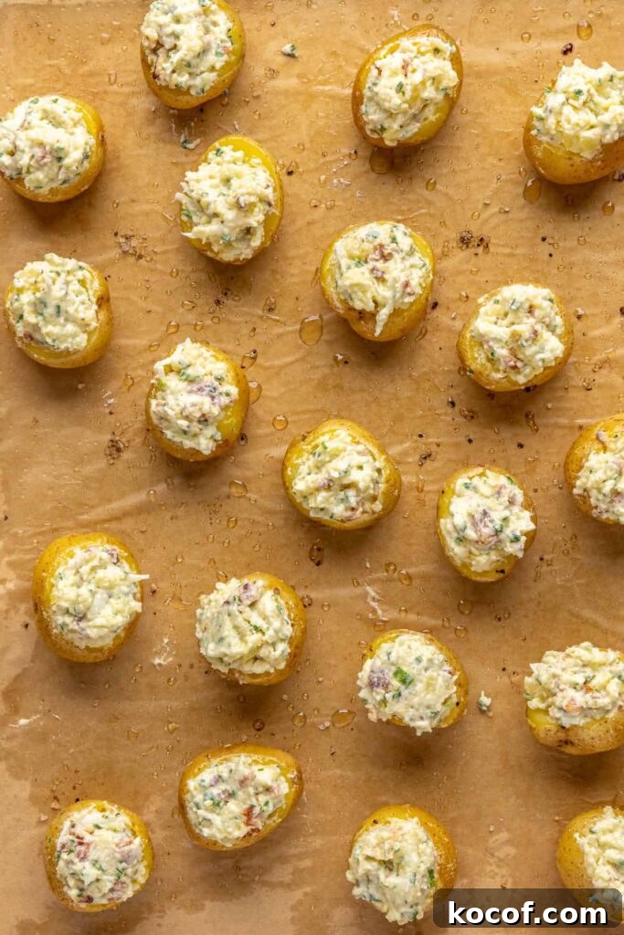 Filling being spooned into baked potato shells