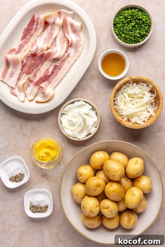 Ingredients for twice baked potatoes including mini Dutch potatoes, goat cheese, ghee, chives, shredded cheddar, chicken stock, and no-sugar-added bacon