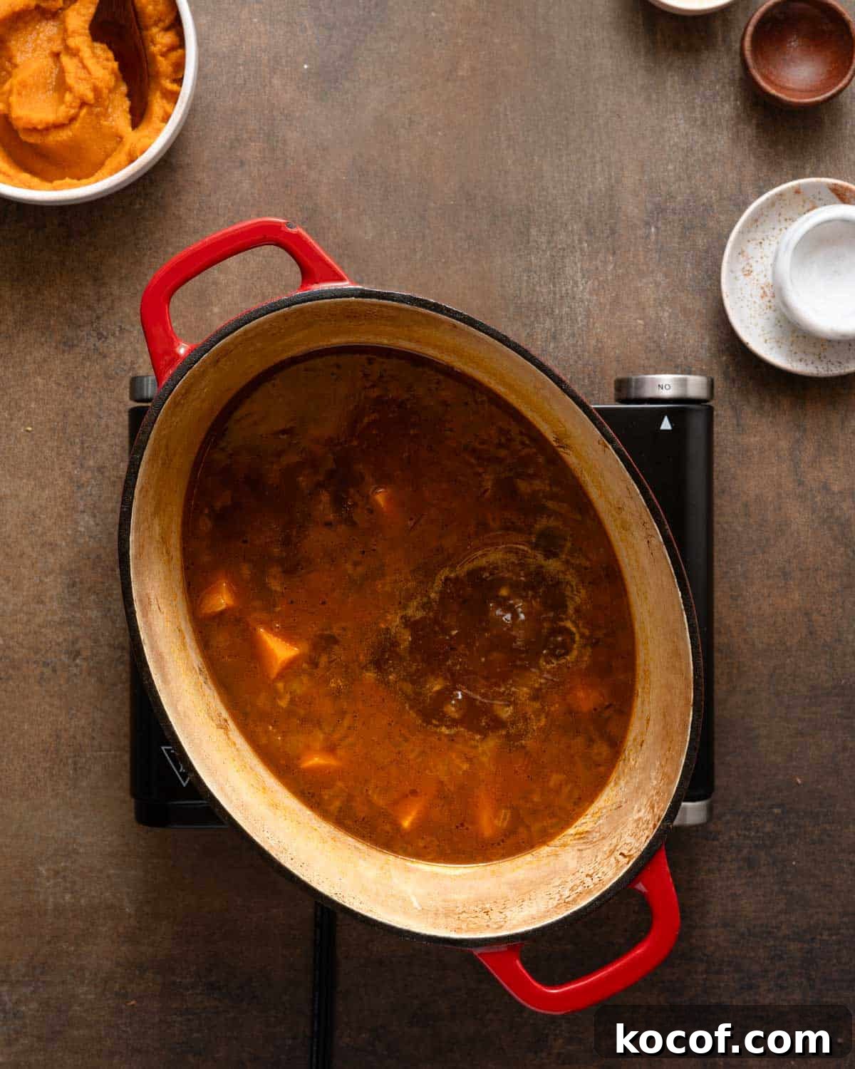 sweet potato soup gently boiling on burner.